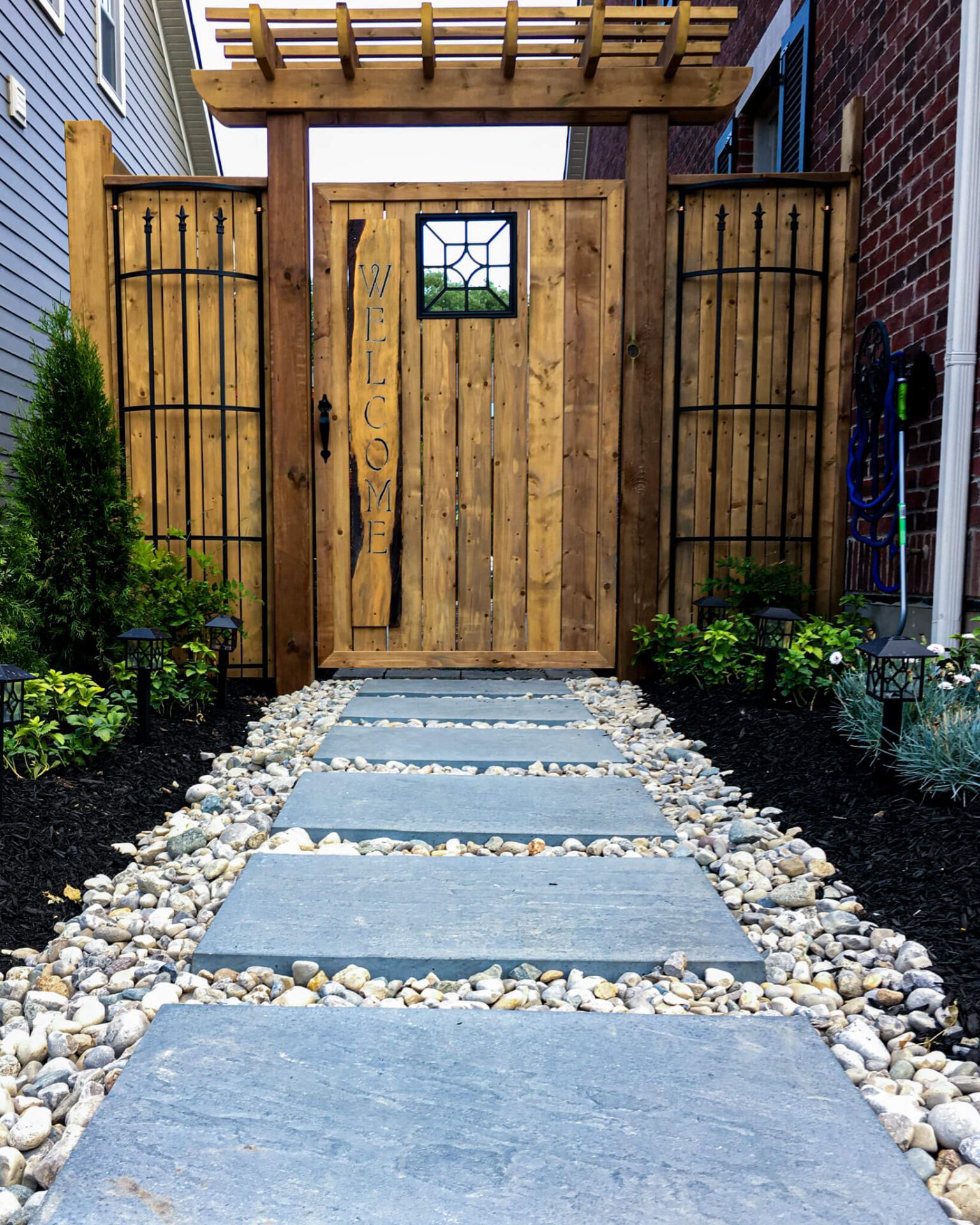 Decorative Stone walkway with black mulch in Hamilton